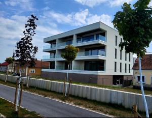 a white building on the side of a road at festina lente in Osijek