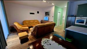a living room with a couch and a table at festina lente in Osijek