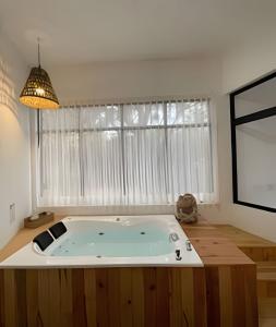 a large bath tub in a room with a window at Villas Buenos Aires / Comodidad y estilo cerca del pueblo in Mazamitla