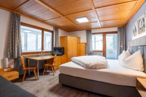 Posteľ alebo postele v izbe v ubytovaní Hotel Garni Madrisa