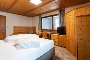 Posteľ alebo postele v izbe v ubytovaní Hotel Garni Madrisa