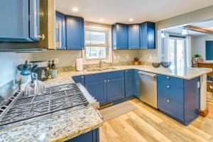 a kitchen with blue cabinets and a stove at Saratoga Springs Vacation Rental with Lake Views! in Saratoga Springs