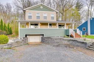 a house with a garage and a blue house at Saratoga Springs Vacation Rental with Lake Views! in Saratoga Springs