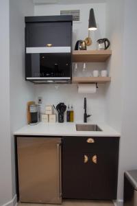 a kitchen with a sink and a microwave at Studio #5 - Self Check-In - Plateau - St-Denis in Montreal +20 photos