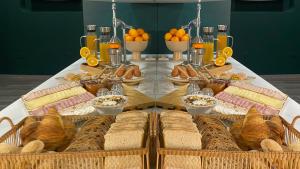a table with a bunch of different types of bread at Hotel Santiago Vagos in Aveiro