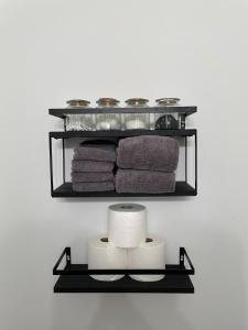 a shelf with towels and towels on a wall at Urban Peak Escape in Lenox +22 photos