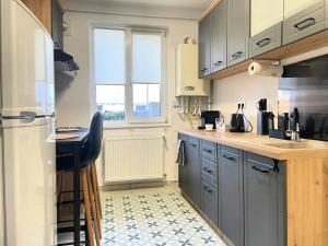a kitchen with gray cabinets and a counter top at Apartament Corvin 1 in Hunedoara
