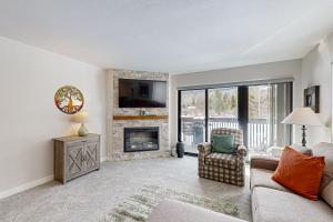 a living room with a couch and a fireplace at Frisco Meadows in Frisco