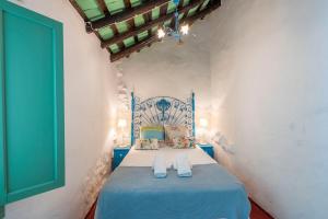 a bedroom with a blue bed in a room at Casa Spa de la Mariola in La Puebla de los Infantes +92 photos