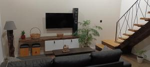 a living room with a couch and a flat screen tv at Casa da Braña in Teo