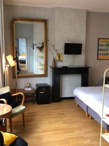 a bedroom with a bed and a mirror and a piano at Logis Pastis in Maastricht +87 photos
