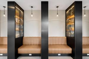 a waiting room with brown seats and lights at Elite Brooklyn Living with Premiere Amenities in Brooklyn