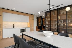 a kitchen and dining room with a table and chairs at Elite Brooklyn Living with Premiere Amenities in Brooklyn +40 photos