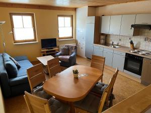 a kitchen and living room with a table and a dining room at Ferienhof Hillenberg in Hausen
