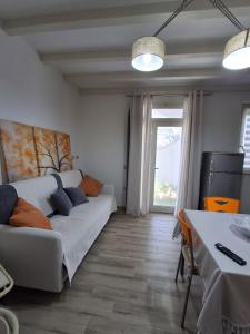 a living room with a couch and a table at Appartamento Valle in Valledoria