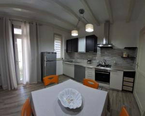 a kitchen with a table and orange chairs in it at Appartamento Valle in Valledoria