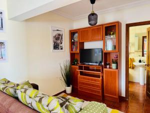 a living room with a couch and a tv at Apartamento as Lombas in Cardón