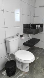 a bathroom with a white toilet in a room at Chalés Boca Da Mata in Piatã +37 photos