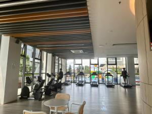 a gym with people exercising on treadmills in a building at Two Bedrooms K-Avenue by CC Suites in Donggongon