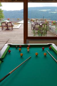 a pool table with balls on top of a deck at Evasion Tonique in Villers-le-Lac