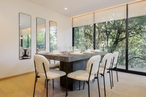 a dining room with a large table and chairs at Saltillo 85, Centric Condo with Balcony and Natural Light in Mexico City +22 photos