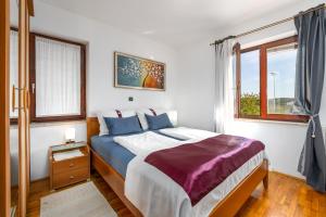 Posteľ alebo postele v izbe v ubytovaní Funtana Apartments Budinjaš