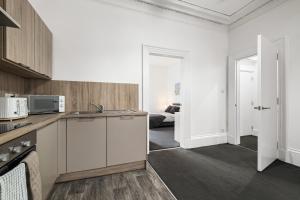a kitchen with a sink and a counter top at Peterhead Pad - SJA Stays - Modern 2 Bed Apartment in Peterhead