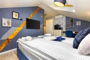 a bedroom with two beds and a flat screen tv at Kapana Art Sky Studios Parking Included in Plovdiv
