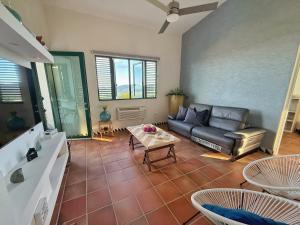a living room with a couch and a table at Luxury Ocean View Penthouse in Rio Grande