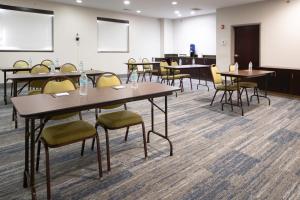 a conference room with tables and chairs and a podium at Holiday Inn Express Hotel & Suites St. Charles by IHG in St. Charles +27 photos