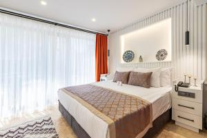 a bedroom with a bed and a large window at BAB - by Menar Hotel in Istanbul