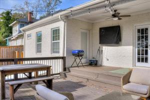 a patio with a table and a tv on a house at Southern luxury retreat Augusta Nat'l golf vibes in Augusta