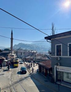 a city street with a train on the tracks at Studio Baščaršija - Sarajevo's prime location in Sarajevo