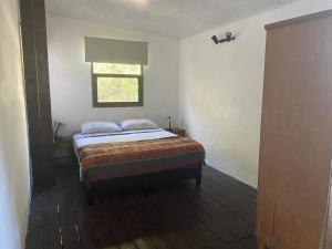 a bedroom with a bed and a window at El Altillo in La Pedrera