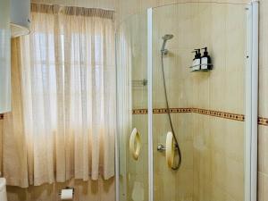 a bathroom with a shower with a glass door at Apartamento as Lombas in Cardón +34 photos