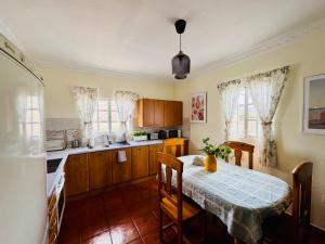 a kitchen with a table and a dining room at Apartamento as Lombas in Cardón