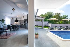 a house with a pool and a kitchen and a living room at Ferienhaus Nana in Marčana +22 photos
