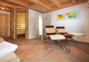 a living room with two chairs and a table at Ferienhaus Wallegg Lodge In Saalbach Hinterglemm in Saalbach Hinterglemm