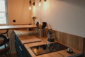 a kitchen with a sink and a counter top at Le Charme - Petite Maison in La Ferté-Bernard