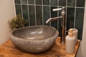 a sink with a faucet in a bathroom at Le Charme - Petite Maison in La Ferté-Bernard