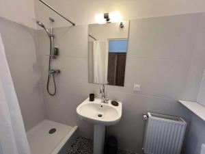a bathroom with a sink and a toilet and a mirror at Résidence 096-soulac Sur Mer - 096 - Séjournez dans le charme de Soulac/mer : maison cosy avec jardin MAE-4441 in Soulac-sur-Mer