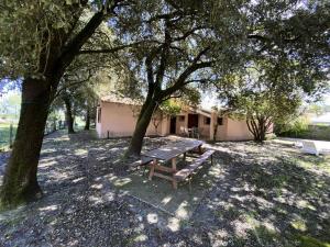 a picnic table in the shade of two trees at Résidence La Grande Combe - 101 - Jolie villa familiale dans quartier calme et résidentiel MAE-4461 in Soulac-sur-Mer