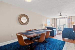 a dining room and living room with a table and chairs at Bahama Sands 1204 in Myrtle Beach