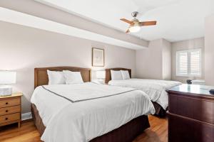 a bedroom with two beds and a ceiling fan at Bahama Sands 1204 in Myrtle Beach +38 photos