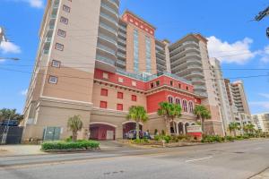 a tall building with palm trees in front of a street at Bahama Sands 1204 in Myrtle Beach