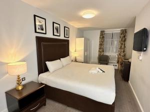 a bedroom with a large white bed and a window at Carlisle Station Hotel, Sure Hotel Collection by BW in Carlisle +49 photos