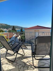 a pair of chairs sitting on a patio at KN House with two apartments near sea in Rogoznica