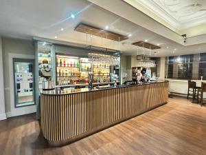a bar in a restaurant with a counter at Carlisle Station Hotel, Sure Hotel Collection by BW in Carlisle