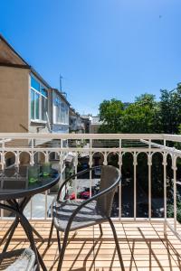 a patio with a table and chairs on a balcony at Odesa city center in Odesa