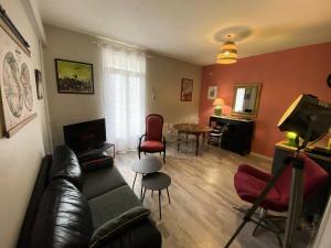 a living room with a couch and a table at Résidence De France - 144 - Appartement en plein cœur du Vieux Soulac MAE-4161 in Soulac-sur-Mer